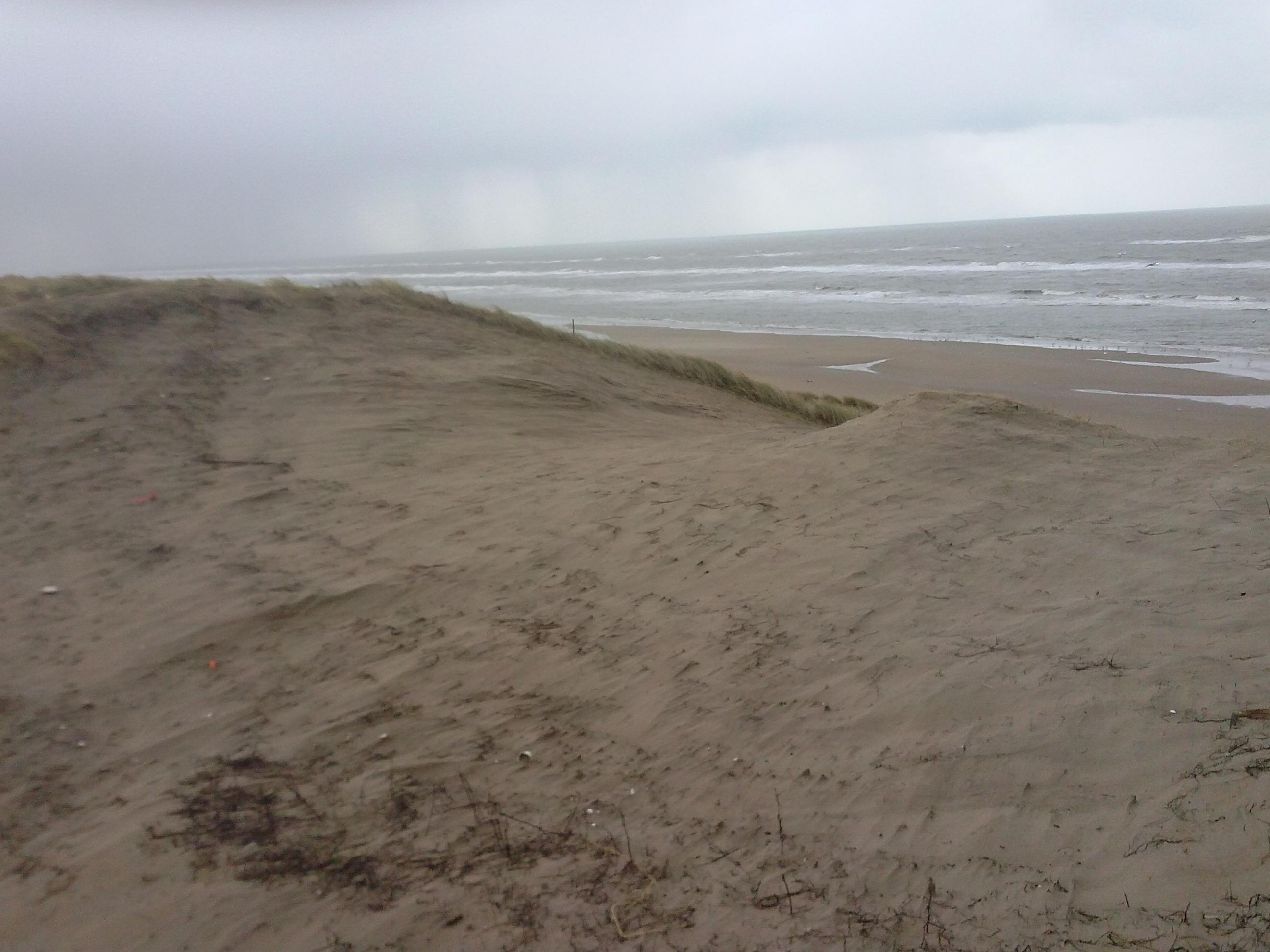 Een kerf in de zeereep voor verstuiving strandzand met uitzicht op zee